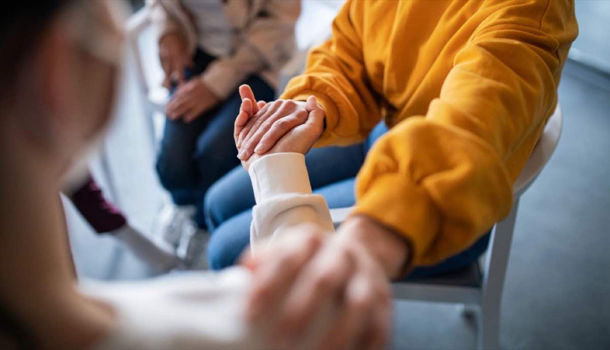 Family members holding hands in a support circle